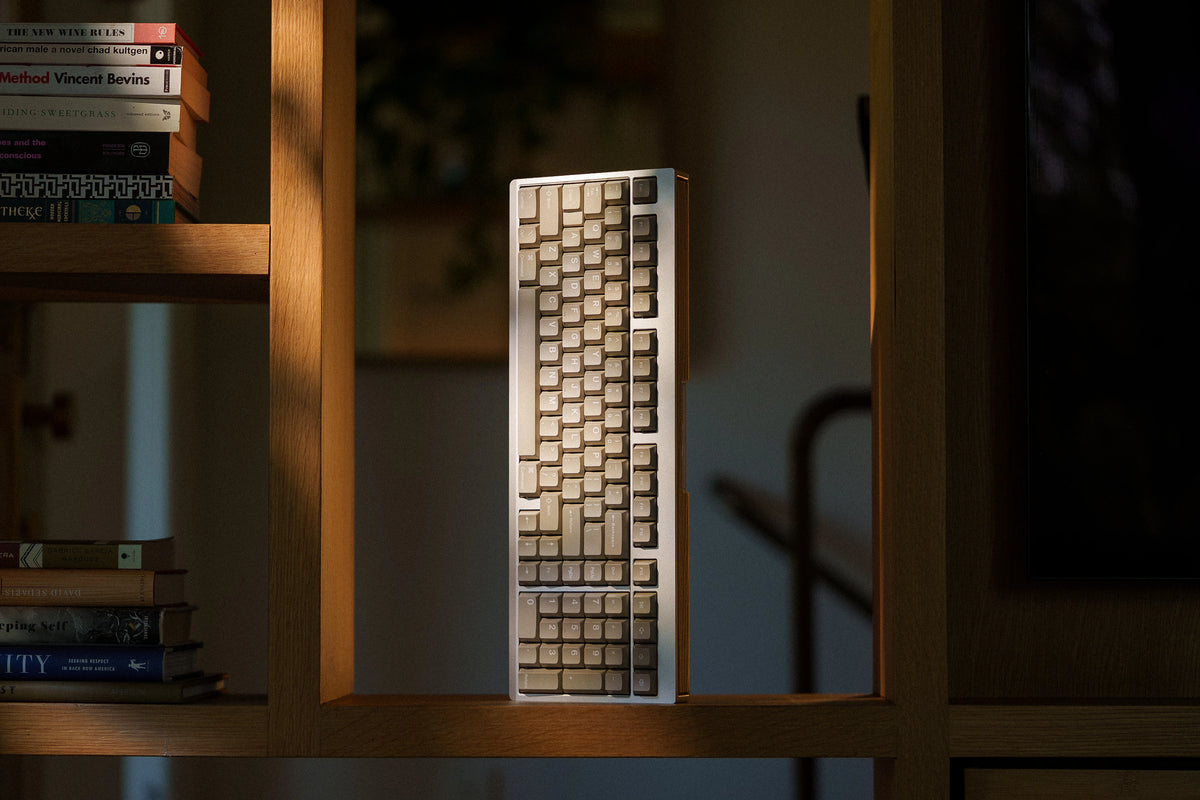 Mode Prologue in Classic Oak standing upright on a wooden bookshelf