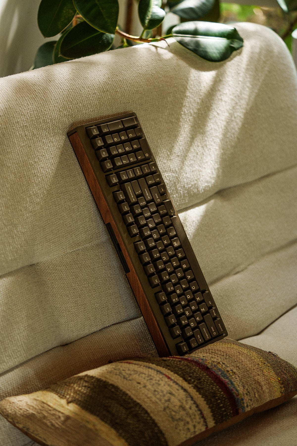 Mode Prologue in Dark Mushroom propped on a cushioned armchair